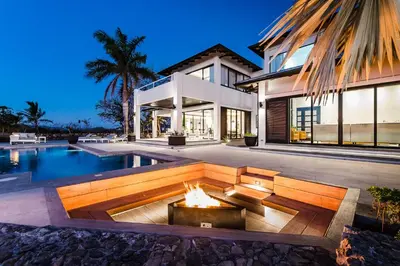 a house with a fire pit in front of a pool at The Point Luxury Villa, Tamarindo in Tamarindo