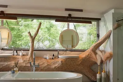 a bathroom with a sink and two mirrors at The Point Luxury Villa, Tamarindo in Tamarindo