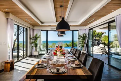 a long dining room with a long table and chairs at The Point Luxury Villa, Tamarindo in Tamarindo
