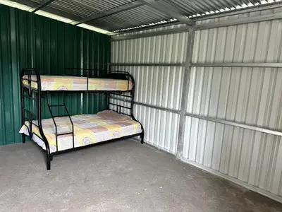 two bunk beds in a room with green walls at Camping El Fosforo in El Fosforo
