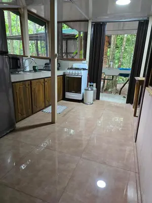 a kitchen with a stove and a counter top at Cool Waters Jungle Hostel in Uvita