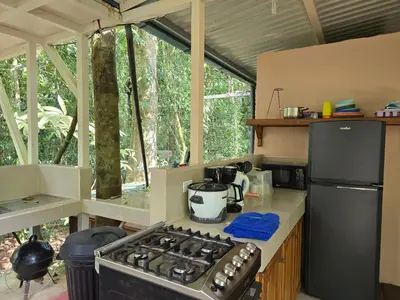 a kitchen with a stove and a stove top oven at Cool Waters Jungle Hostel in Uvita