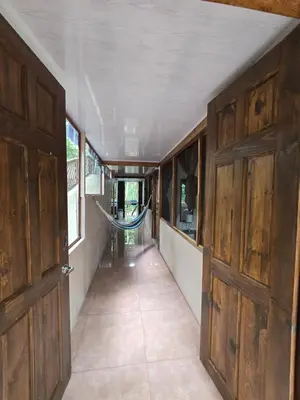 an open door of a train with a hallway at Cool Waters Jungle Hostel in Uvita