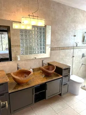 two wooden sinks in a bathroom with a mirror at Casa del Artista 4bed,4 bath Ocean view home in Playa Hermosa