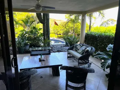 a patio with a table and chairs and a pool at Casa del Artista 4bed,4 bath Ocean view home in Playa Hermosa