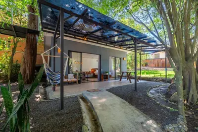 a patio of a house with a roof at Bromelia Studio in Monteverde Costa Rica