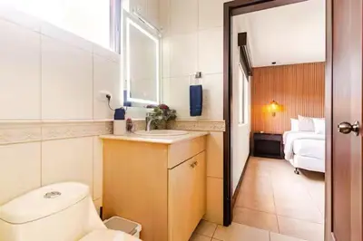 a bathroom with a toilet and a sink and a bed at Palmas de Tamarindo Resort, 304E in Guanacaste