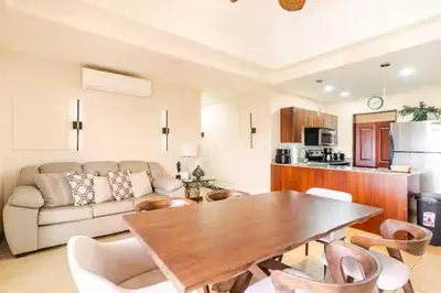 a living room with a table and a couch at Palmas de Tamarindo Resort, 304E in Guanacaste