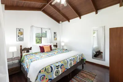 a bedroom with a bed with a colorful comforter at Angels Mar Villa Hermosa 2b2b European Villa in Playa Hermosa