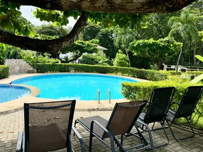 a group of chairs sitting next to a swimming pool at Angels Mar Villa Hermosa 2b2b European Villa in Playa Hermosa