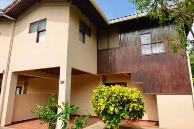 a house with a tree in front of it at Angels Mar Villa Hermosa 2b2b European Villa in Playa Hermosa