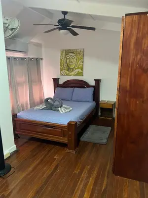 a bedroom with a bed with a ceiling fan at Enchanting 3 BR 2 Bath Condo in the Heart of Jaco in Jacó