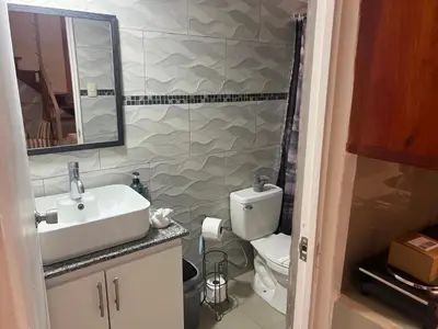 a bathroom with a sink and a toilet at Enchanting 3 BR 2 Bath Condo in the Heart of Jaco in Jacó