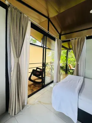 a bedroom with a bed and a balcony at Cabañas La Hermosa #2 in Guápiles