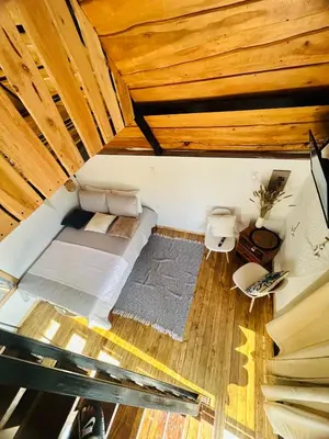 an overhead view of a bed in a room with wooden ceilings at Hotel en Huacas y Brasilito in Matapalo