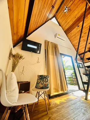 a room with a table and chairs and a staircase at Hotel en Huacas y Brasilito in Matapalo