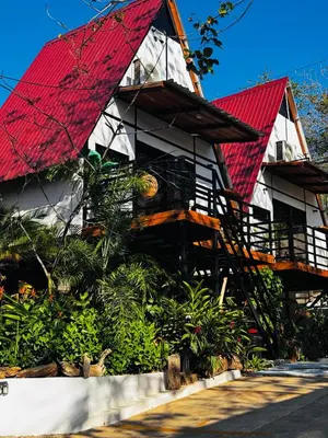 a building with a red roof and a building at Hotel en Huacas y Brasilito in Matapalo