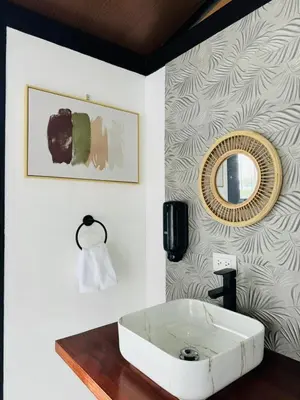 a bathroom with a white sink and a mirror at Cabañas La Hermosa #1 in Guápiles