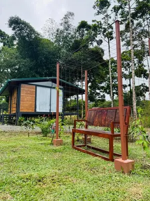 a swing in front of a tiny house at Cabañas La Hermosa #1 in Guápiles