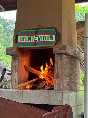 a pizza oven with a fire inside of it at Cabañas La Hermosa #1 in Guápiles