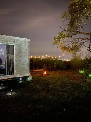 a truck parked in a field at night at Cedro lodge in Fraijanes