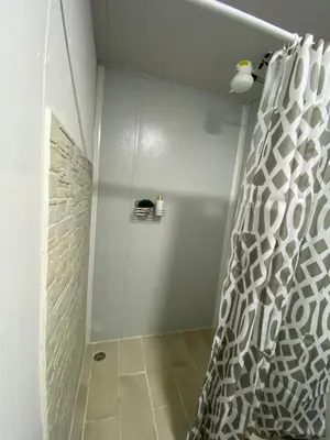 a shower with a shower curtain in a bathroom at Cedro lodge in Fraijanes
