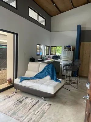 a room with a bed and a desk in it at Tiny Bosque del Barro in Barrio Jesús