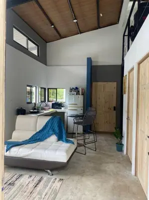 a living room with a white couch and a table at Tiny Bosque del Barro in Barrio Jesús