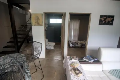 a living room with a couch a table and a staircase at Tiny Bosque del Barro in Barrio Jesús