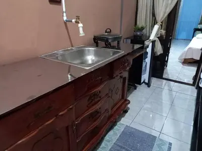 a bathroom with a sink on a wooden counter at Tita's House in Jarasal