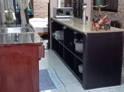 a kitchen with a sink and a counter with figurines on it at Tita's House in Jarasal