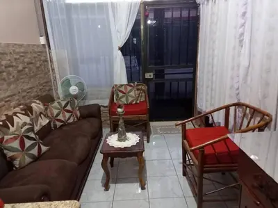 a living room with a couch and chairs and a table at Tita's House in Jarasal