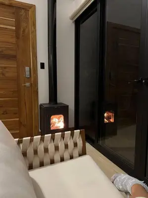 a bedroom with a wood stove in a room at Nest Chalet Monteverde in Monteverde Costa Rica