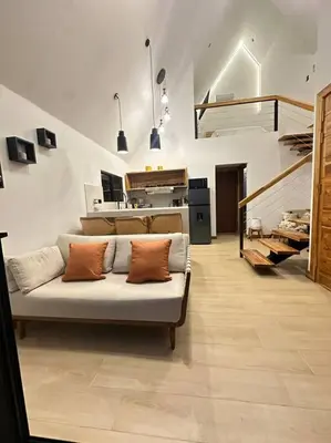 a living room with a couch with two pillows on it at Nest Chalet Monteverde in Monteverde Costa Rica