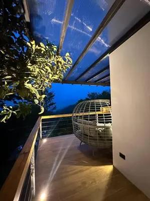a balcony with a bird cage on top of it at Nest Chalet Monteverde in Monteverde Costa Rica