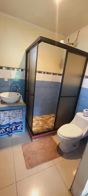 a bathroom with a shower and a toilet and a sink at Green leaf house in Fortuna