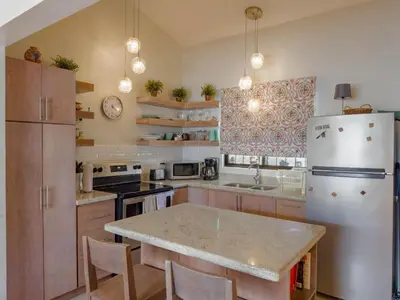 a kitchen with a white refrigerator and a counter top at Emerald Haven Second Floor Studio Mins from Beach in Coco