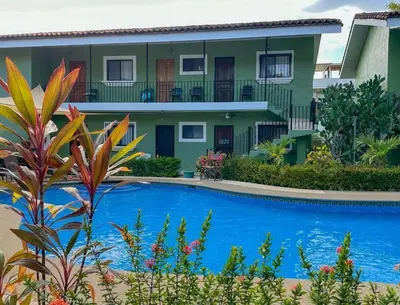 a house with a swimming pool in front of it at Emerald Haven Second Floor Studio Mins from Beach in Coco