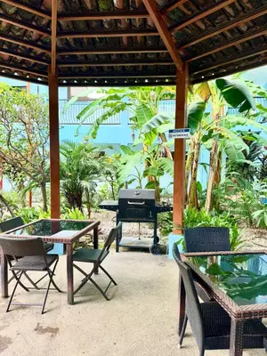 a patio with tables and chairs and a grill at Marine Beach Bliss Ground Floor Studio in Coco
