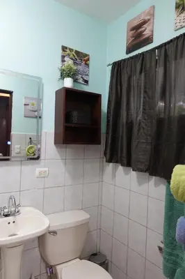 a bathroom with a toilet and a sink at Marine Beach Bliss Ground Floor Studio in Coco