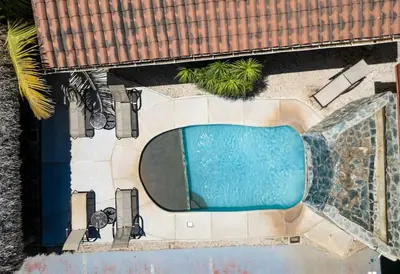 an overhead view of a swimming pool at a resort at Comfortable Vacation Home Steps from the Beach in Playa Grande