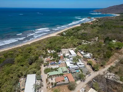 an aerial view of a house and the beach at Comfortable Vacation Home Steps from the Beach in Playa Grande