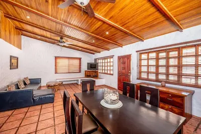 a living room with a table and a couch at Comfortable Vacation Home Steps from the Beach in Playa Grande
