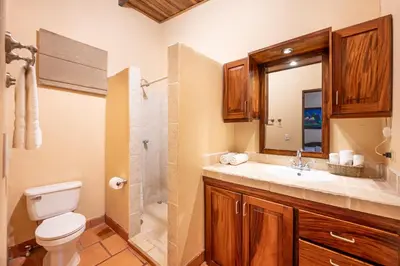 a bathroom with a toilet and a sink and a shower at Charming Studio with Pool & Beach Access in Playa Grande