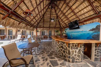a resort with a bar with chairs and a table at Charming Studio with Pool & Beach Access in Playa Grande