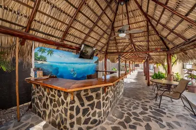 a bar in a resort with a view of the ocean at Charming Studio with Pool & Beach Access in Playa Grande