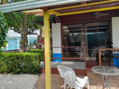 a patio with a table and chairs and an umbrella at BeachBungalow Surf&Stay in Patos