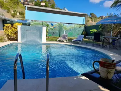 a large swimming pool with a table and chairs at BeachBungalow Surf&Stay in Patos