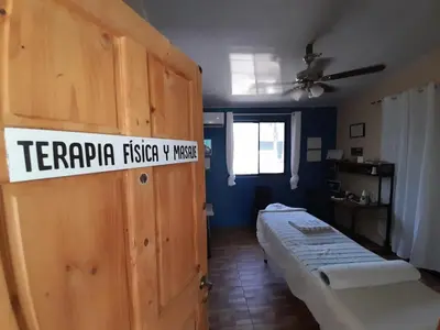 a room with two beds and a sign on a door at BeachBungalow Surf&Stay in Patos