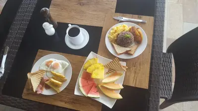 two plates of breakfast food on a table at Beachfront Hotel Tramonto in Jacó